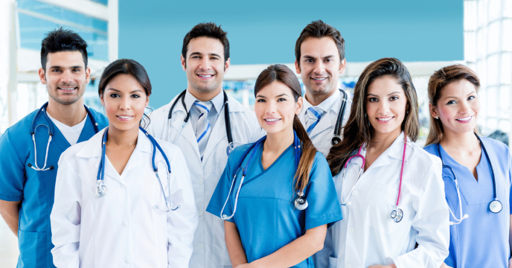 a team of seven diverse doctors poses in a group