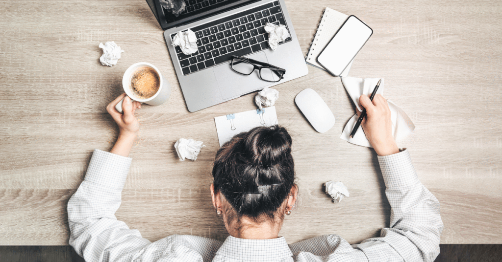 a birds-eye view of a woman asleep at work with her head on her desk